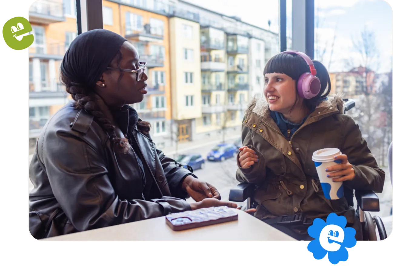 Two friends connect at a coffee shop.